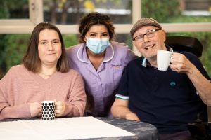 Support worker Malik with Jessica and Harry